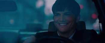 Movie still from “No Strings Attached” (2011), directed by Ivan Reitman – A man sitting in the drivers seat of a car; Close Up shot, Over the shoulder angle