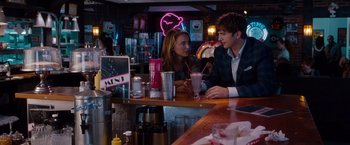 Movie still from “No Strings Attached” (2011), directed by Ivan Reitman – A man and a woman sitting at a bar; Medium shot, Over the shoulder angle