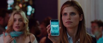 Movie still from “No Strings Attached” (2011), directed by Ivan Reitman – A woman holding up a cell phone in front of her face; Close Up shot, Over the shoulder angle