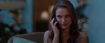 Movie still from “No Strings Attached” (2011), directed by Ivan Reitman – A beautiful young lady talking on a cell phone; Close Up shot, Over the shoulder angle