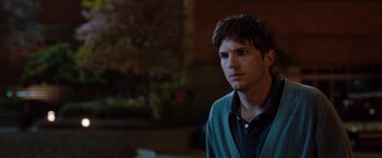 Movie still from “No Strings Attached” (2011), directed by Ivan Reitman – A man in a sweater looking into the distance; Close Up shot, Over the shoulder angle