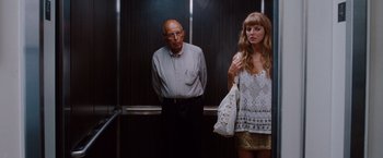 Movie still from “No Strings Attached” (2011), directed by Ivan Reitman – A man and a woman standing in an elevator next to each other; Medium shot, Over the shoulder angle