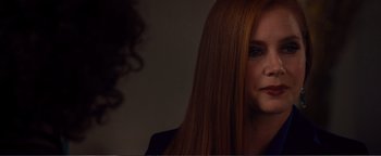 Movie still from “Nocturnal Animals” (2016), directed by Tom Ford – A person with long red hair; Close Up shot, Over the shoulder angle