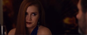 Movie still from “Nocturnal Animals” (2016), directed by Tom Ford – A person with long red hair; Close Up shot, Over the shoulder angle