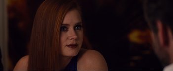 Movie still from “Nocturnal Animals” (2016), directed by Tom Ford – A beautiful young woman with long red hair and blue eyes; Close Up shot, Over the shoulder angle