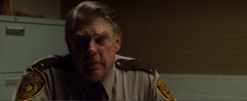 Movie still from “Nocturnal Animals” (2016), directed by Tom Ford – A person wearing a police uniform; Close Up shot, Over the shoulder angle