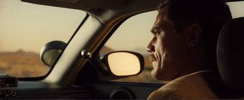 Movie still from “Nocturnal Animals” (2016), directed by Tom Ford – A person in a car looking out of the window; Close Up shot, Over the shoulder angle