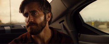 Movie still from “Nocturnal Animals” (2016), directed by Tom Ford – A person with a beard; Close Up shot, Low angle