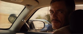 Movie still from “Nocturnal Animals” (2016), directed by Tom Ford – A person in a car looking at a mirror; Close Up shot, Over the shoulder angle