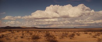 Movie still from “Nocturnal Animals” (2016), directed by Tom Ford – A desert landscape with a large cloud in the sky; Extreme Wide shot, High angle