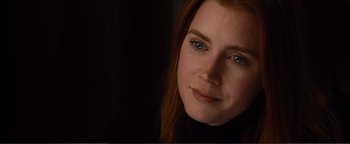 Movie still from “Nocturnal Animals” (2016), directed by Tom Ford – A person with long red hair; Close Up shot, Over the shoulder angle