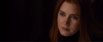 Movie still from “Nocturnal Animals” (2016), directed by Tom Ford – A person with long red hair; Close Up shot, Over the shoulder angle