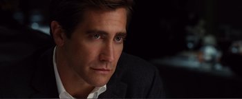 Movie still from “Nocturnal Animals” (2016), directed by Tom Ford – A person wearing a suit and tie; Close Up shot, Over the shoulder angle
