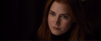Movie still from “Nocturnal Animals” (2016), directed by Tom Ford – A person with long red hair; Close Up shot, Over the shoulder angle