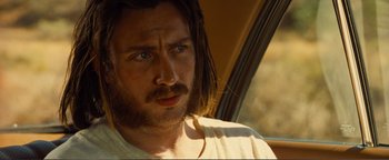 Movie still from “Nocturnal Animals” (2016), directed by Tom Ford – A person with long hair and a beard; Close Up shot, Over the shoulder angle