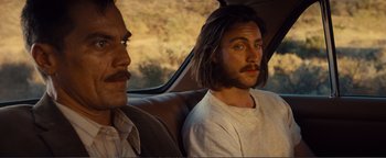 Movie still from “Nocturnal Animals” (2016), directed by Tom Ford – Two men sitting in the back seat of a car; Close Up shot, Over the shoulder angle