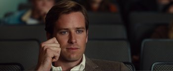 Movie still from “Nocturnal Animals” (2016), directed by Tom Ford – A person wearing a suit holding a cell phone to his ear; Close Up shot, Over the shoulder angle