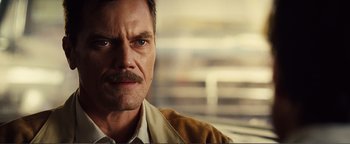Movie still from “Nocturnal Animals” (2016), directed by Tom Ford – A person with a mustache; Close Up shot, Over the shoulder angle