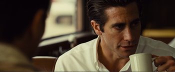 Movie still from “Nocturnal Animals” (2016), directed by Tom Ford – A person wearing a white shirt; Close Up shot, Over the shoulder angle