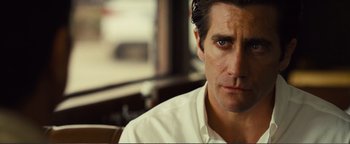 Movie still from “Nocturnal Animals” (2016), directed by Tom Ford – A person wearing a white shirt; Close Up shot, Over the shoulder angle