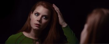 Movie still from “Nocturnal Animals” (2016), directed by Tom Ford – A woman with long red hair and a green shirt; Close Up shot, Over the shoulder angle