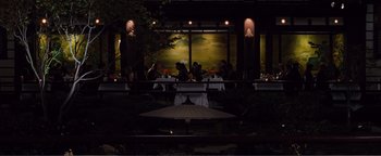 Movie still from “Nocturnal Animals” (2016), directed by Tom Ford – A group of people sitting at a table in a restaurant; Extreme Wide shot, High angle