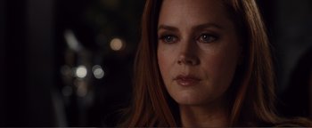 Movie still from “Nocturnal Animals” (2016), directed by Tom Ford – A woman's face with a blurry background; Close Up shot, Over the shoulder angle