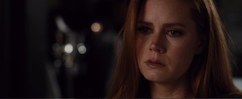 Movie still from “Nocturnal Animals” (2016), directed by Tom Ford – A person with long red hair; Close Up shot, Over the shoulder angle