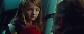 Movie still from “Non-Stop” (2014), directed by Jaume Collet-Serra – A young girl is looking at a mirror; Close Up shot, Over the shoulder angle