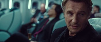 Movie still from “Non-Stop” (2014), directed by Jaume Collet-Serra – A person sitting on a bus; Close Up shot, Over the shoulder angle