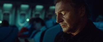 Movie still from “Non-Stop” (2014), directed by Jaume Collet-Serra – A person sitting on a bus; Close Up shot, Low angle