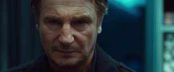 Movie still from “Non-Stop” (2014), directed by Jaume Collet-Serra – A man's face in a dark room; Close Up shot, Low angle