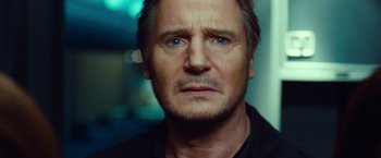 Movie still from “Non-Stop” (2014), directed by Jaume Collet-Serra – A person wearing a black shirt; Close Up shot, Over the shoulder angle