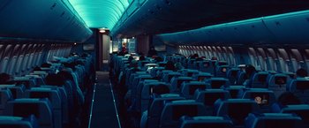 Movie still from “Non-Stop” (2014), directed by Jaume Collet-Serra – The interior of an airplane is lit up at night; Wide shot, High angle