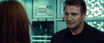Movie still from “Non-Stop” (2014), directed by Jaume Collet-Serra – A man and a woman standing in front of a refrigerator; Close Up shot, Over the shoulder angle