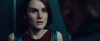 Movie still from “Non-Stop” (2014), directed by Jaume Collet-Serra – A person looking at the camera; Close Up shot, Over the shoulder angle