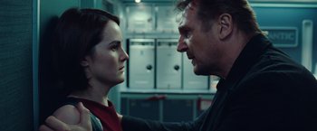 Movie still from “Non-Stop” (2014), directed by Jaume Collet-Serra – A man and a woman face to face in a kitchen; Close Up shot, Low angle