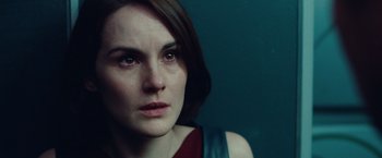 Movie still from “Non-Stop” (2014), directed by Jaume Collet-Serra – A person looking at the camera; Close Up shot, Over the shoulder angle