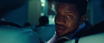 Movie still from “Non-Stop” (2014), directed by Jaume Collet-Serra – A person sitting in a car; Close Up shot, Low angle
