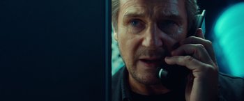 Movie still from “Non-Stop” (2014), directed by Jaume Collet-Serra – Liam neeson talking on a phone; Close Up shot, Low angle