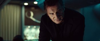 Movie still from “Non-Stop” (2014), directed by Jaume Collet-Serra – Liam neeson looking at the camera; Close Up shot, Low angle