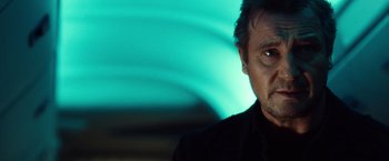 Movie still from “Non-Stop” (2014), directed by Jaume Collet-Serra – A person wearing a black shirt; Close Up shot, Low angle