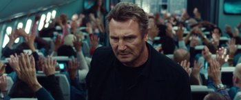 Movie still from “Non-Stop” (2014), directed by Jaume Collet-Serra – Liam neeson in a crowd of people; Close Up shot, Over the shoulder angle