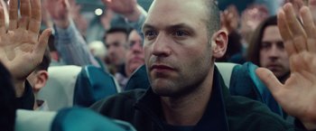 Movie still from “Non-Stop” (2014), directed by Jaume Collet-Serra – A person sitting in a train; Close Up shot, Low angle