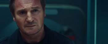 Movie still from “Non-Stop” (2014), directed by Jaume Collet-Serra – A person wearing a black shirt; Close Up shot, Low angle