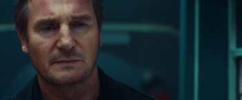 Movie still from “Non-Stop” (2014), directed by Jaume Collet-Serra – A man's face in a dark room; Close Up shot, Low angle