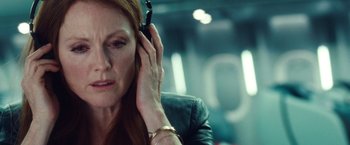 Movie still from “Non-Stop” (2014), directed by Jaume Collet-Serra – A person talking on a cell phone; Close Up shot, Low angle