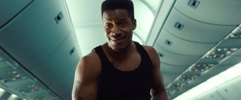 Movie still from “Non-Stop” (2014), directed by Jaume Collet-Serra – A person with a tattoo on his chest; Close Up shot, Low angle