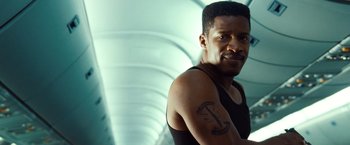 Movie still from “Non-Stop” (2014), directed by Jaume Collet-Serra – A person with a tattoo on his arm; Close Up shot, Low angle