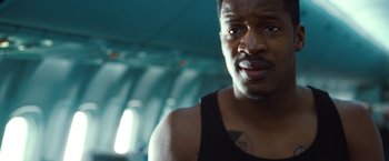 Movie still from “Non-Stop” (2014), directed by Jaume Collet-Serra – A person wearing a tank top; Close Up shot, Low angle